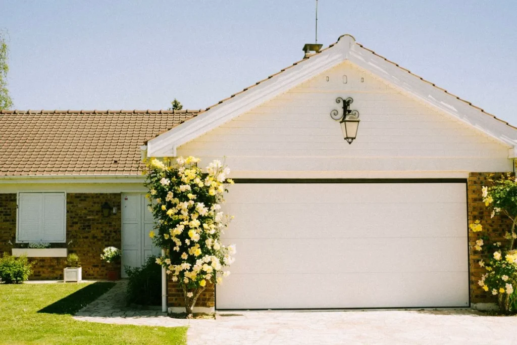 Best siding for Calgary climate on a white lap-sided garage gable with brick accents