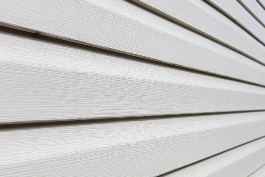 Close-up of white woodgrain lap siding showing hardie board siding cost calgary