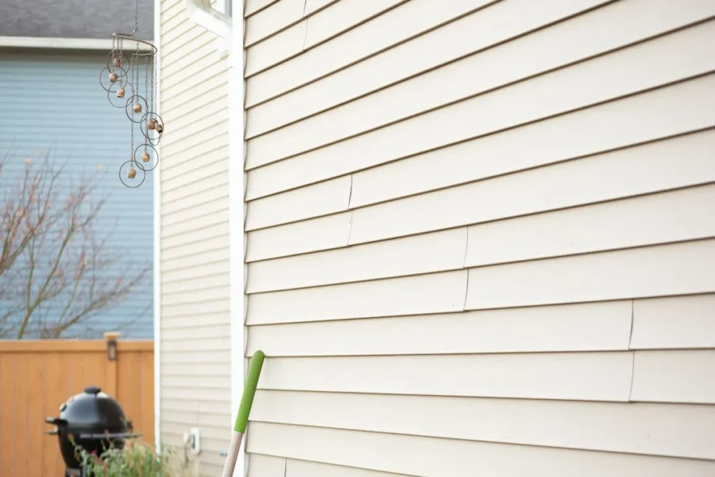 Siding replacement cost Calgary signs shown by cracked panels on a home exterior